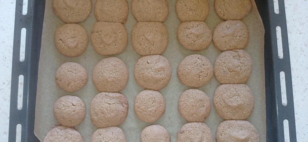 Halva cookies freshly baked on a parchment-lined tray