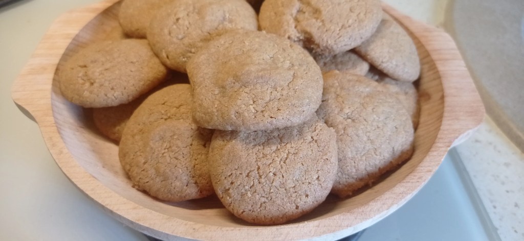 A pile of halva cookies served in a rustic wooden bowl